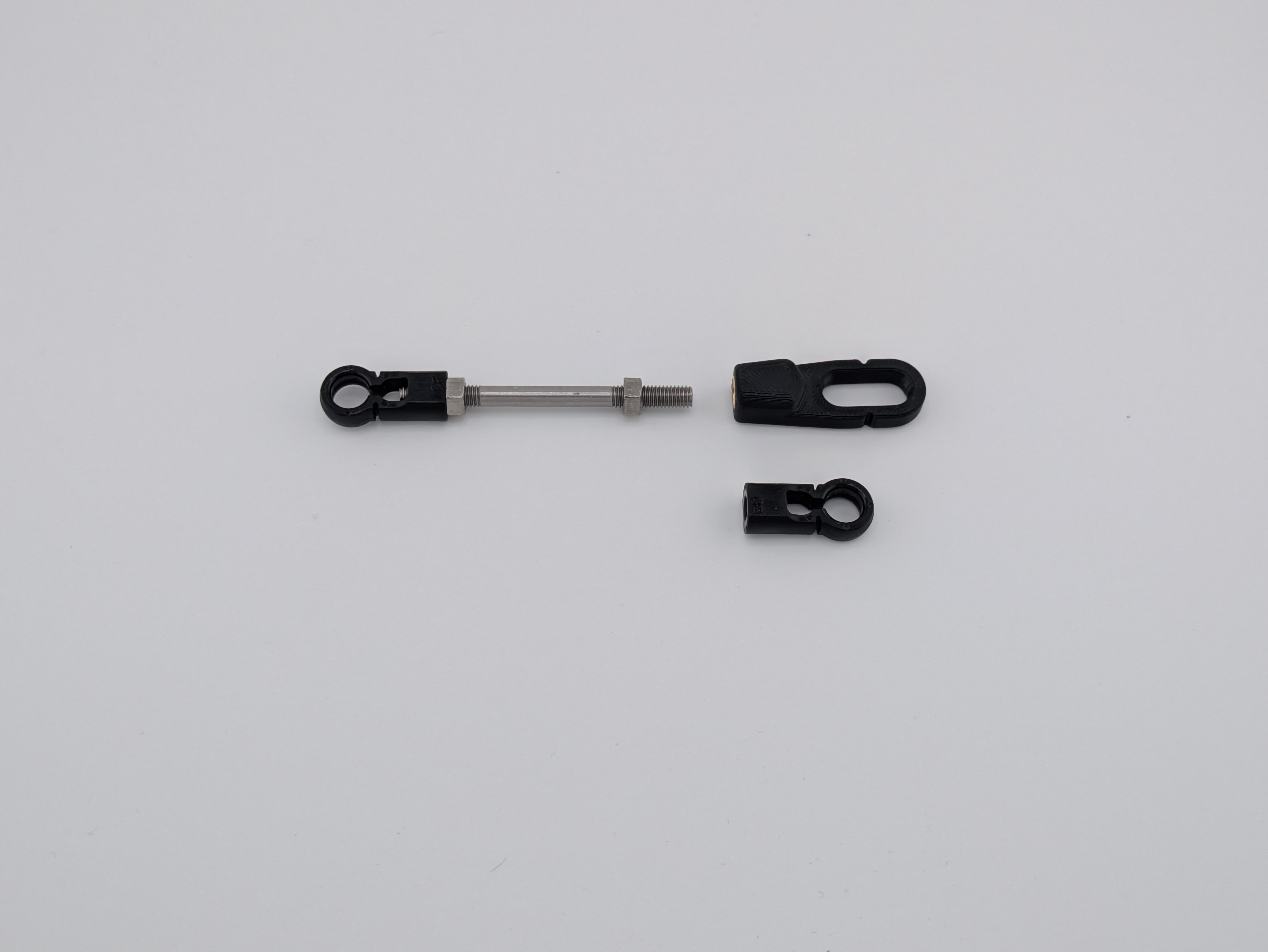 OEM pushrod connector set aside and the kit's extended loop connector ready to install