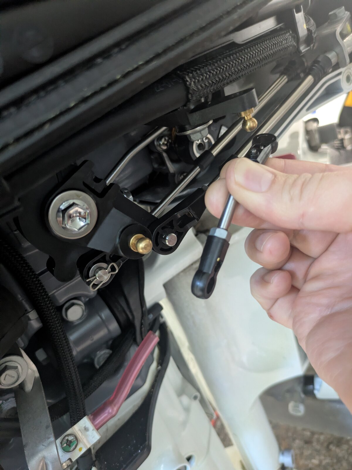 Disconnecting the forward end of the throttle pushrod