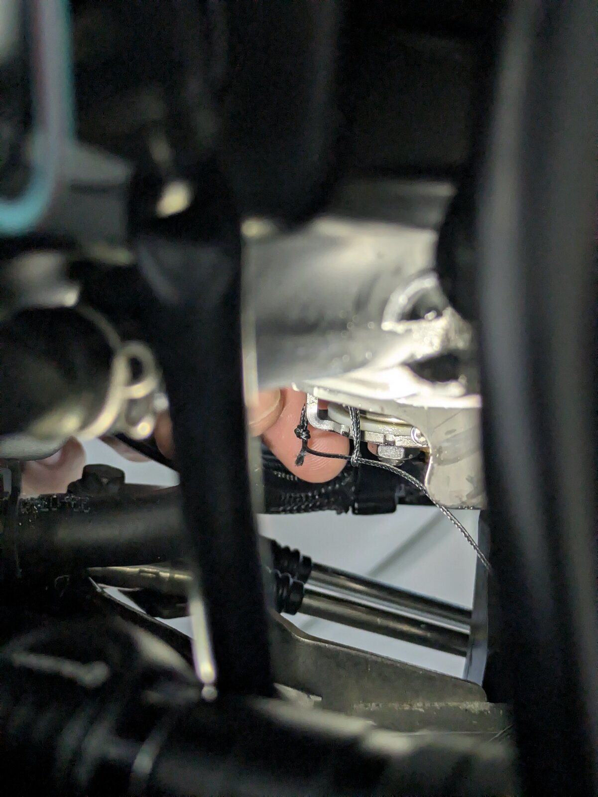 Looping the braided cable around the throttle body tab